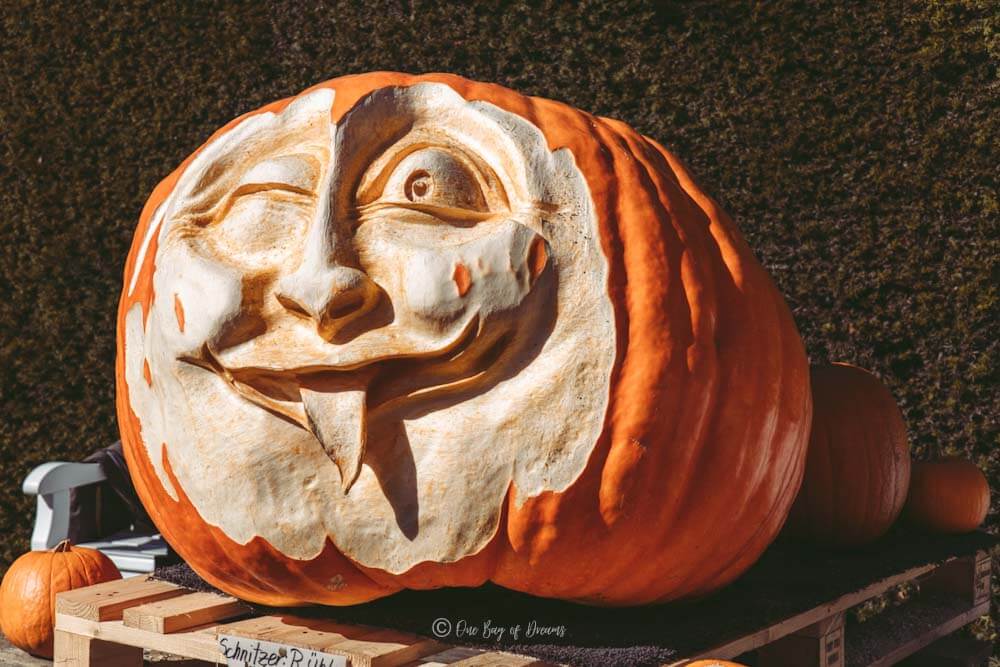 A carved pumpkin in the shape of a face